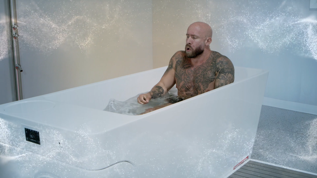 A muscular man in a cold plunge.